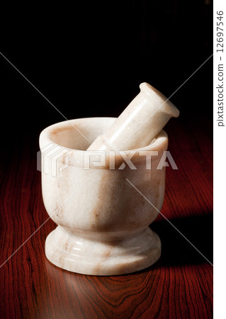 Marble mortar and pestle on dark 12697546