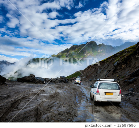Vehicles on bad road in Himalayas 12697696
