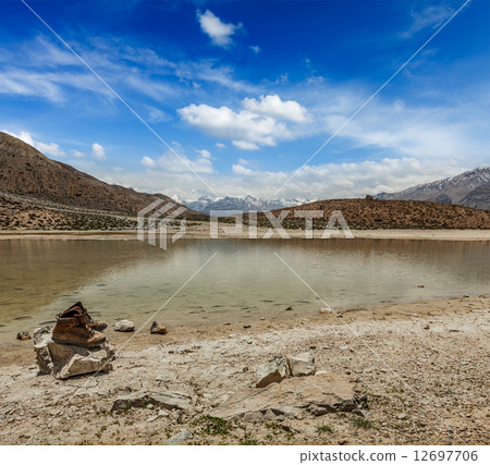 Trekking hiking boots at mountain lake in Himalayas 12697706