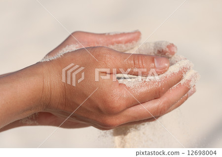 Sand running through hands 12698004