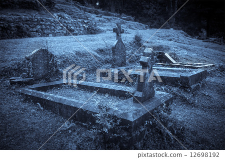 Spooky Halloween graveyard in fog 12698192