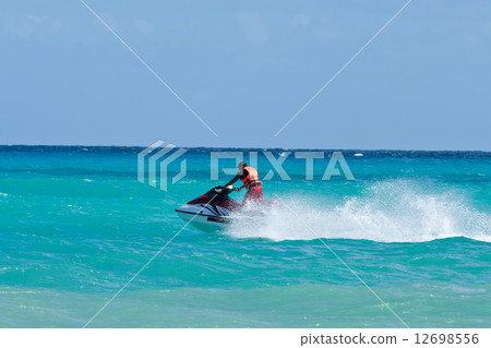 Man riding jet ski 12698556
