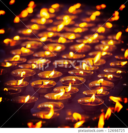 Burning candles in Buddhist temple, McLeod Ganj 12698725
