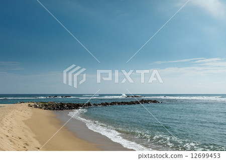 Wave breaker on beach Wave breaker on beach 12699453