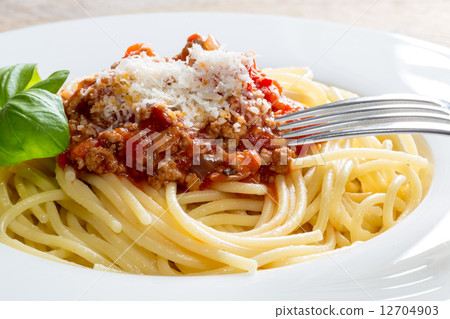 Spaghetti with Bolognese Sauce Parmesan and basil 12704903