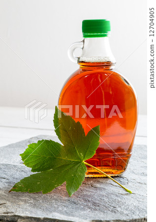 Maple syrup in a bottle on stone plate 12704905