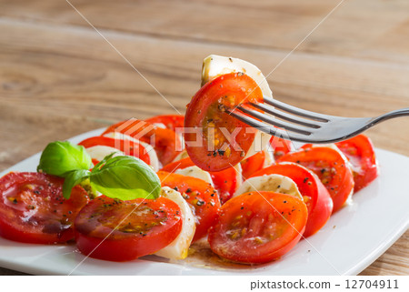 Caprese salad tomato mozzarella with basil 12704911
