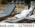 Young beautiful woman relaxing on a beach chair 12706663