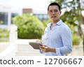 Serious business man using a tablet computer 12706667