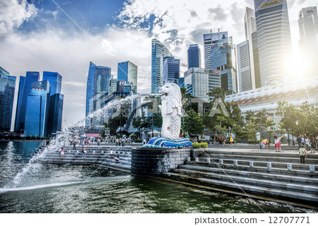 SINGAPORE-OCT 28: The Merlion fountain and Marina Bay Sand on OCT, 28, 2014. Merlion is an imaginary SINGAPORE-OCT 28: The Merlion fountain and Marina Bay Sand on OCT, 28, 2014. Merlion is an imaginary 12707771