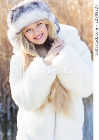Cute little girl in winter clothes outdoors 12708827