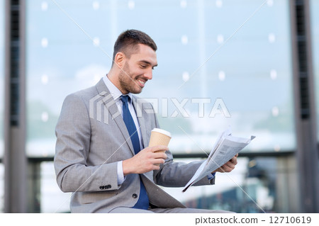 young businessman with coffee and newspaper 12710619