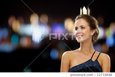 smiling woman in evening dress wearing crown 12710686