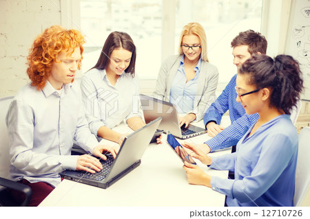 smiling team with laptop and table pc computers 12710726