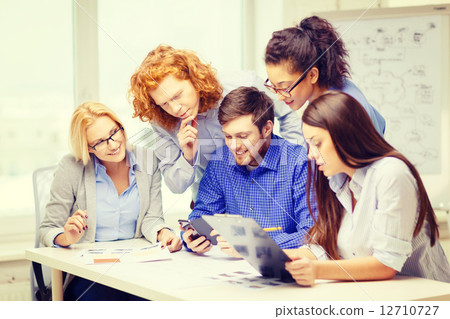 creative team with papers and clipboard at office 12710727
