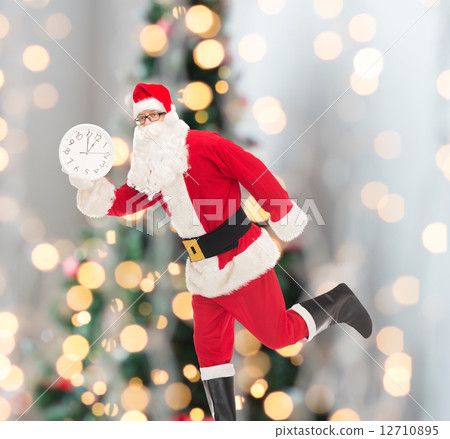 man in costume of santa claus with clock man in costume of santa claus with clock 12710895