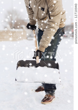 closeup of man digging snow with shovel closeup of man digging snow with shovel 12710940