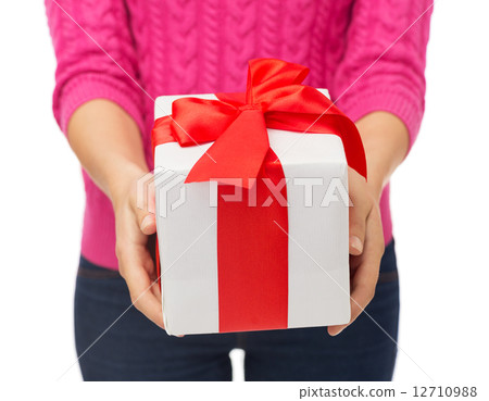 close up of woman in pink sweater holding gift box close up of woman in pink sweater holding gift box 12710988