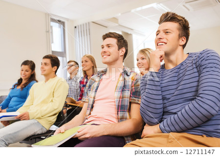 group of smiling students in lecture hall 12711147