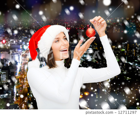 woman in santa helper hat with christmas ball 12711297
