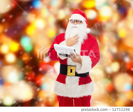 man in costume of santa claus with notepad man in costume of santa claus with notepad 12711298
