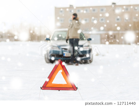 closeup of man with broken car and smartphone closeup of man with broken car and smartphone 12711440