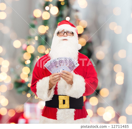 man in costume of santa claus with euro money man in costume of santa claus with euro money 12711485