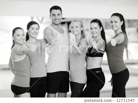 group of people in the gym showing thumbs up 12711545