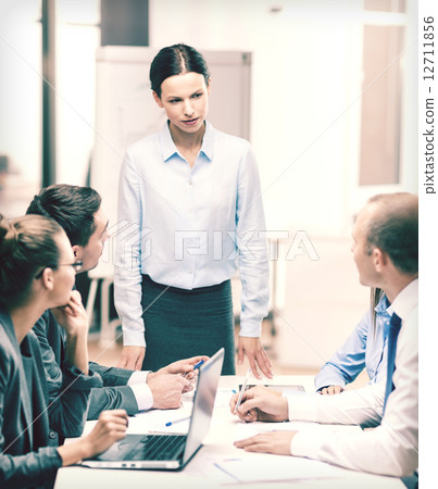 strict female boss talking to business team 12711856