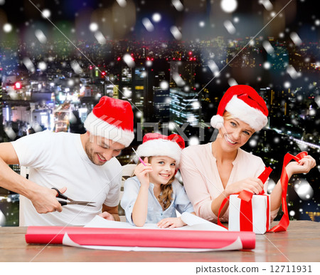 happy family in santa helper hats packing gift happy family in santa helper hats packing gift 12711931