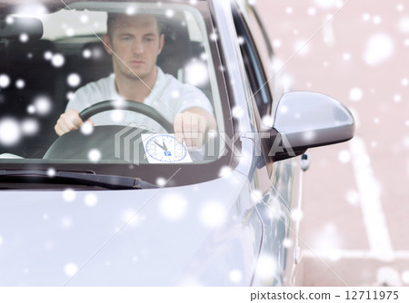 man driving car and putting parking clock man driving car and putting parking clock 12711975