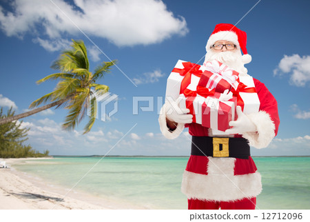 man in costume of santa claus with gift boxes man in costume of santa claus with gift boxes 12712096