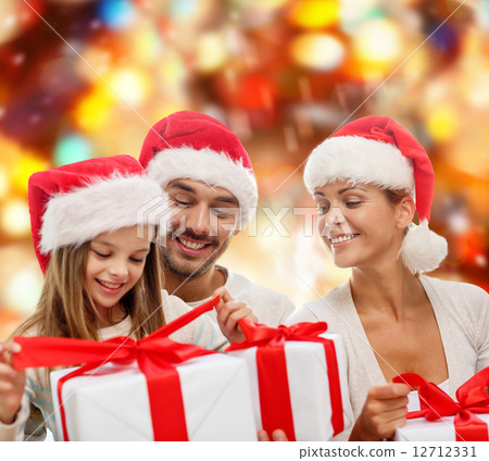 happy family in santa helper hats with gift boxes happy family in santa helper hats with gift boxes 12712331