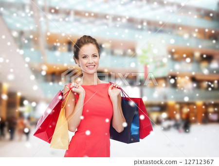 smiling woman with colorful shopping bags 12712367