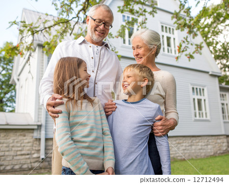 happy family in front of house outdoors happy family in front of house outdoors 12712494