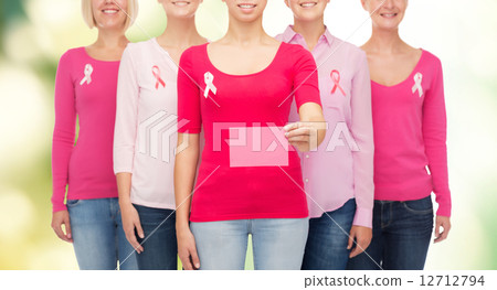 close up of women with cancer awareness ribbons close up of women with cancer awareness ribbons 12712794