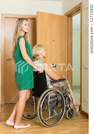 Girl helping handicapped woman Girl helping handicapped woman 12715882