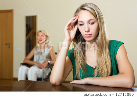 Tired woman and disabled person 12715890