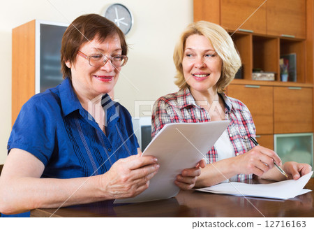 Notary officer helping aged client 12716163