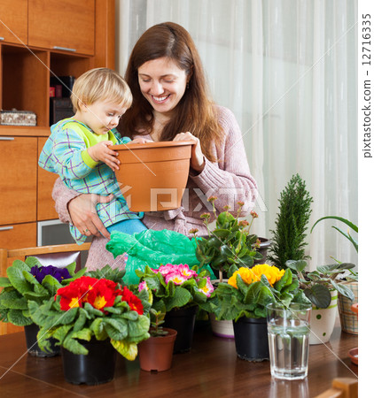 Mother and baby with flowering plants Mother and baby with flowering plants 12716335