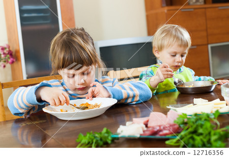 serious children eating food 12716356