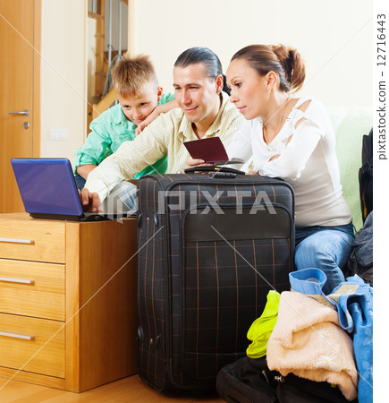 Happy family of three reserving resort on internet Happy family of three reserving resort on internet 12716443