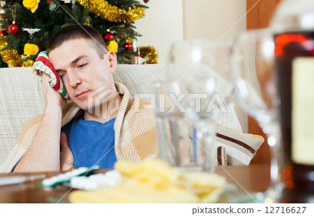 Guy having hangover after celebrating New year Guy having hangover after celebrating New year 12716627