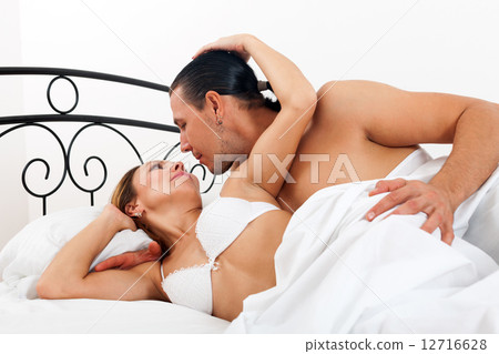 couple in bed in bedroom 12716628