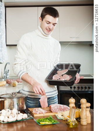 man cooking meat man cooking meat 12716633