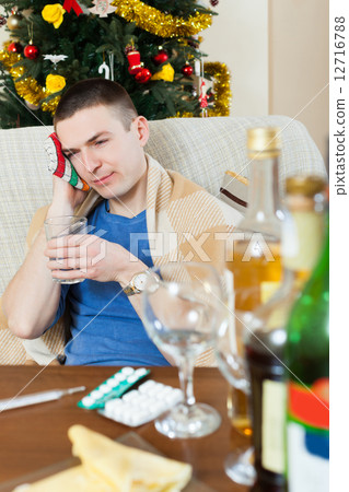 Young man having headache after celebrating New Year 12716788