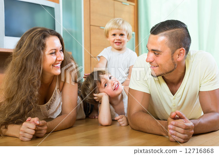 Happy family of four at home Happy family of four at home 12716868