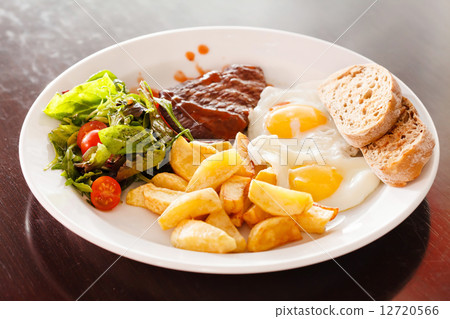 steak with eggs and vegetables 12720566