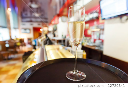 glass of champagne in cafe 12720841
