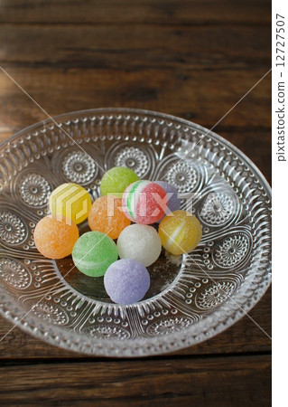 Sugar coated colorful hard candies on a glass plate Sugar coated colorful hard candies on a glass plate 12727507